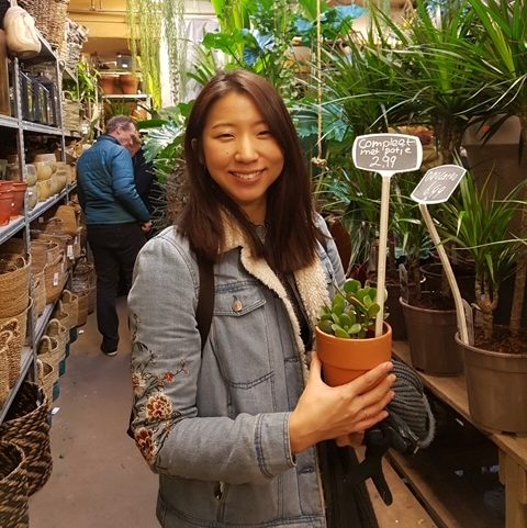 happy sophie holding a plant pot